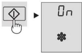 Diagram showing a hand pressing a diamond-shaped button next to a digital display with 'On' and a snowflake symbol.