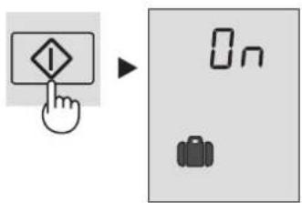 Diagram showing a hand pressing a warning symbol next to a digital display with 'On' and a backpack icon