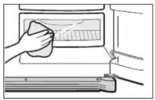 Illustration of a hand cleaning a microwave oven with a cloth (no text or symbols)