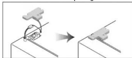 Diagram showing a mechanical assembly or tool interacting with a component, indicated by an arrow (no text or symbols present)