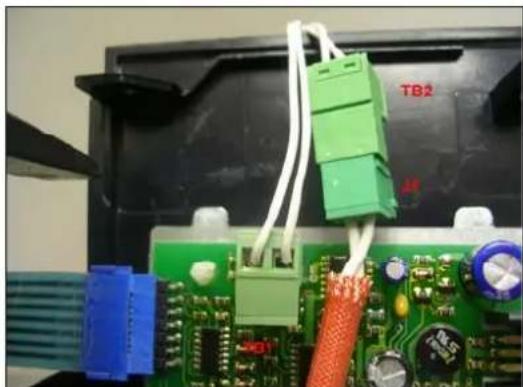 Close-up of a green circuit board with connectors and wiring, no visible text or symbols