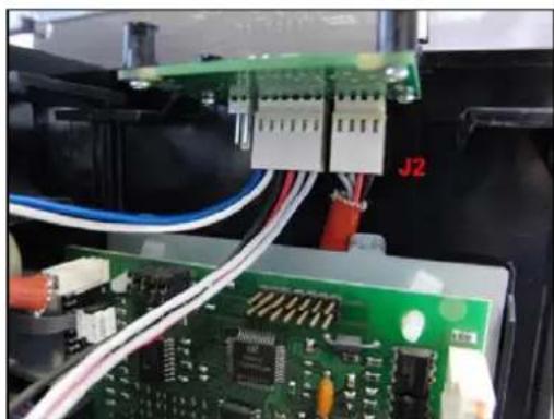 Close-up of a green circuit board with wiring and connectors, no visible text or symbols