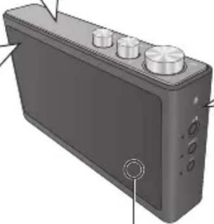 Illustration of a black rectangular electronic device with three circular tops and a circular button on the front panel (no text or symbols visible)