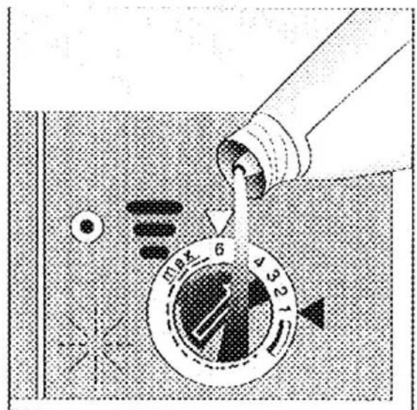 Diagram showing a device with labeled parts and directional arrows, likely illustrating a process or control mechanism.