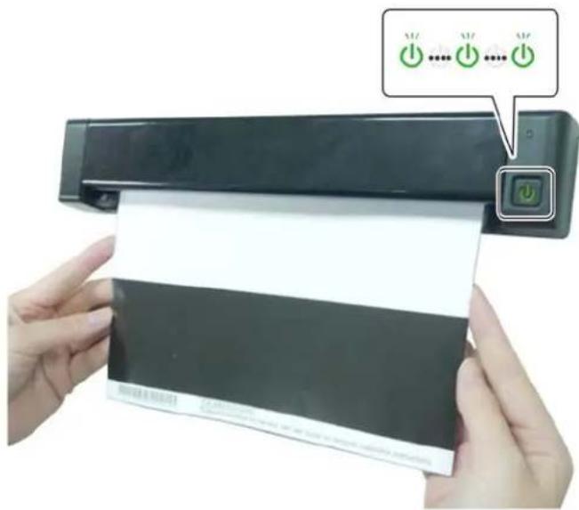 Person holding a printed document with three green power button icons above it, indicating status or activation.