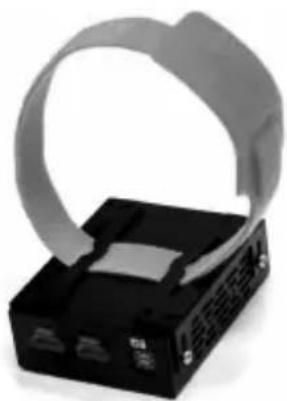 Close-up of a black electronic device with a gray ribbon-like strap attached to its side (no visible text or symbols)