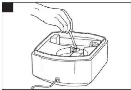 Line drawing of a hand using a tool to adjust or install an electronic device into a square box (no text or symbols)