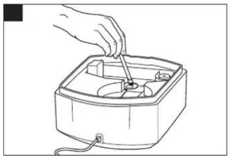 Line drawing of a hand using a tool to adjust or install an electronic device into a square container (no text or symbols)
