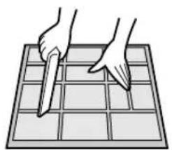 Illustration of two hands cutting a grid on a tray (no text or symbols)