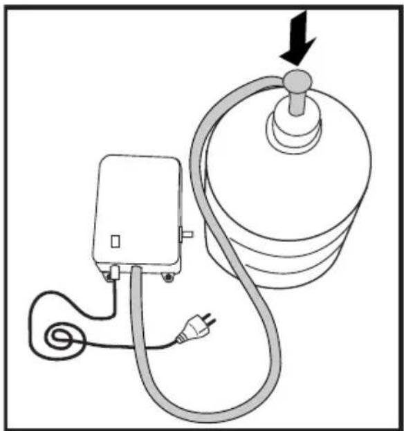 Diagram of a medical or electrical device connected to a cylindrical device with a plug, showing wiring and a downward arrow (no text or symbols)