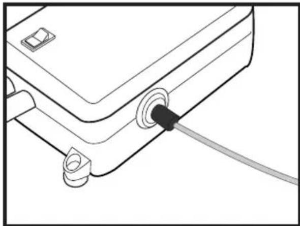 Line drawing of a device with a cable inserted into a corner socket (no text or symbols)