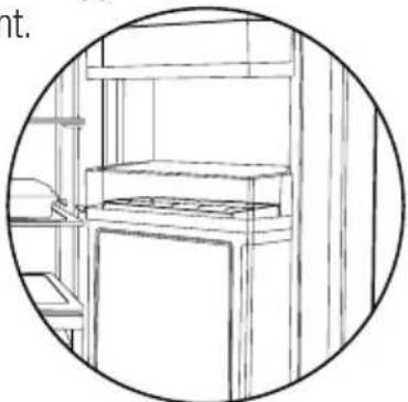 Line drawing of a kitchen appliance with shelves and a counter (no text or symbols).