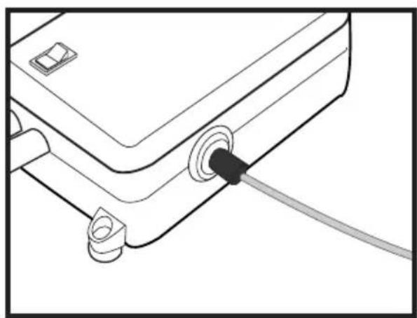 Line drawing of a device with a cable inserted into a connector (no text or symbols).