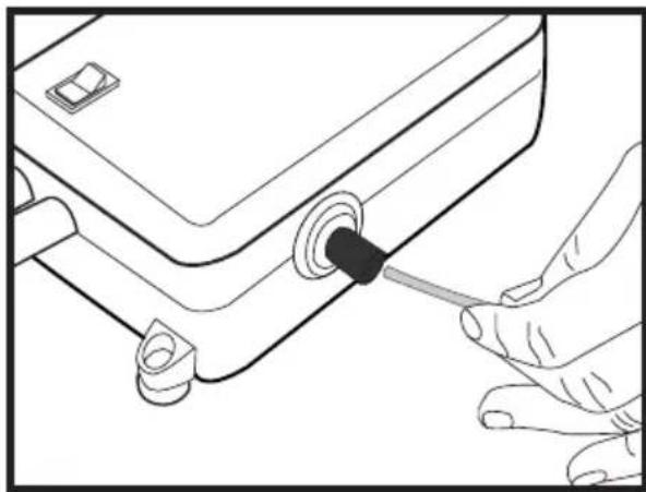 Line drawing of hands inserting a plug into a device component.