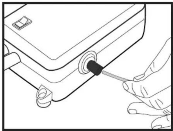 Line drawing of hands using a tool to adjust or install a component with a black hole (no text or symbols).