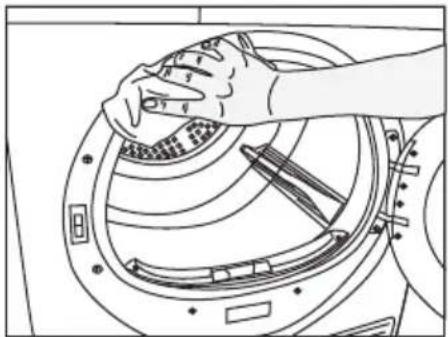 Line drawing of a hand cleaning a circular mechanical component with tools, no text or symbols.