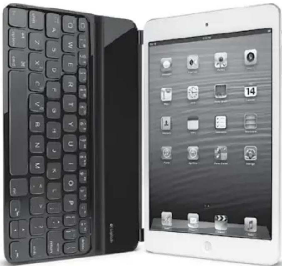 Two electronic devices: a black keyboard with open lid and a white tablet displaying app icons (no readable text or symbols on keys).