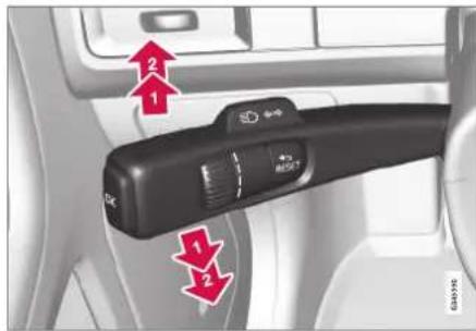 Car interior control panel with directional arrows and labeled buttons, showing vehicle status indicators