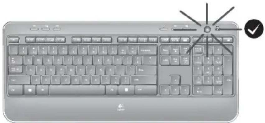 Illustration of a standard computer keyboard with a starburst icon and checkmark (no text or symbols on the main body)