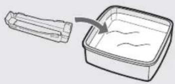 Diagram showing a container being placed with a handle, indicating surface or material (no text or symbols present).