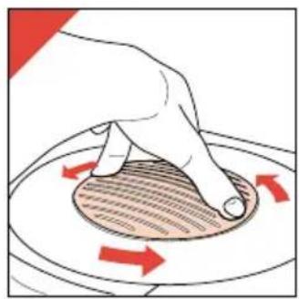 Hand pressing down on a circular object with red arrows indicating motion (no text or symbols).