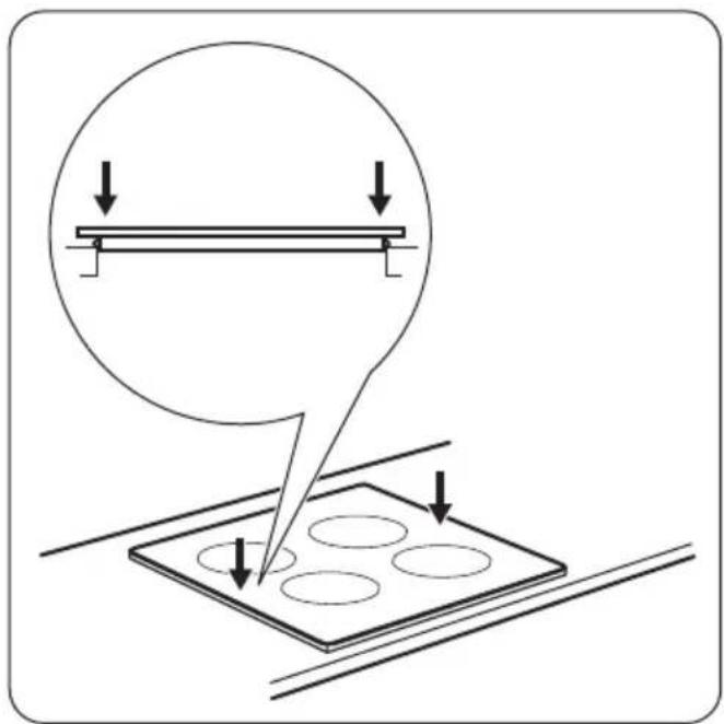 Diagram showing a circular object with downward arrows pointing to a plate with four circular holes, no text or symbols present.