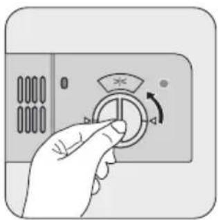 Hand holding a circular control knob with an arrow indicating rotation (no text or symbols)