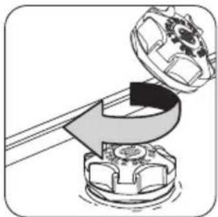 Mechanical assembly diagram showing a rotating component with a gear-like top and a curved arrow indicating motion (no text or symbols)