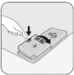 Illustration of a hand using a tool to press or install a device with a curved arrow (no text or symbols).