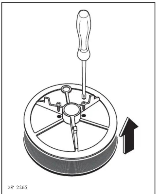 Mechanical diagram showing a screwdriver inserted into a circular component with an upward arrow indicating motion (no text or symbols).