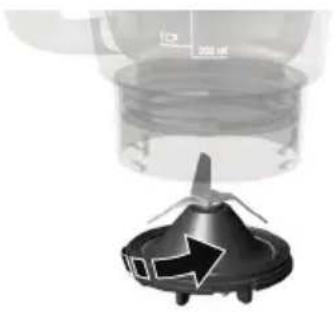 Close-up of a mechanical component with a black triangular base and a transparent cylindrical top, showing internal structure (no text or symbols visible)