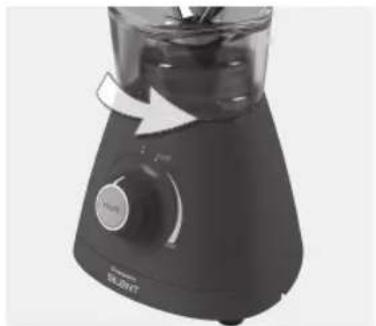 Close-up of a black blender with control knob and arrow indicator.