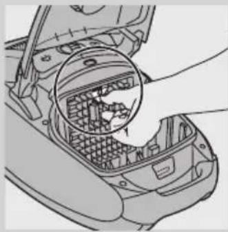 Diagram of a car interior showing a hand inserting a plastic container into the engine compartment (no text or symbols visible).
