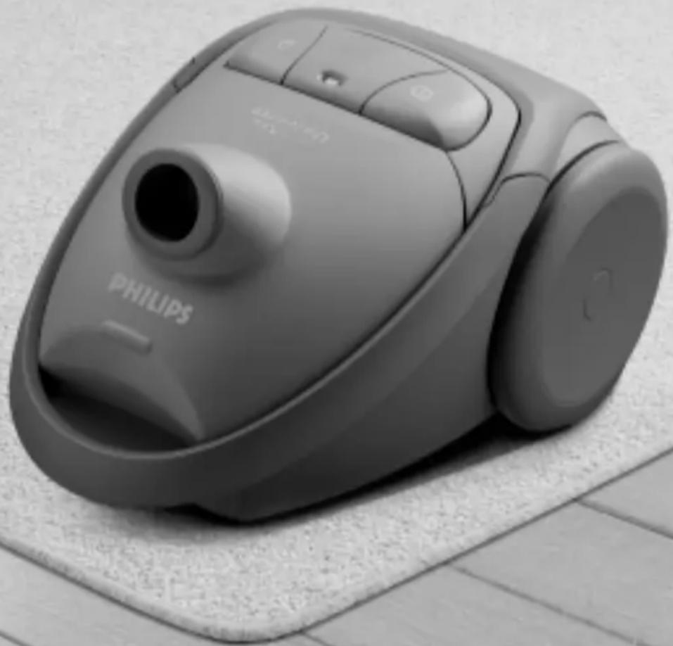 Black-and-white photo of a Philips vacuum cleaner on a textured surface (no visible text or symbols)