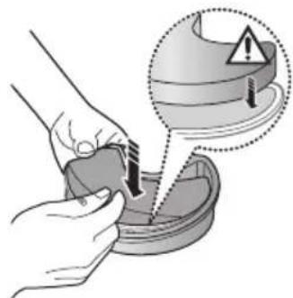 Illustration of a hand using a tool to clean or inspect a surface, with an inset showing warning symbols (no text or labels).