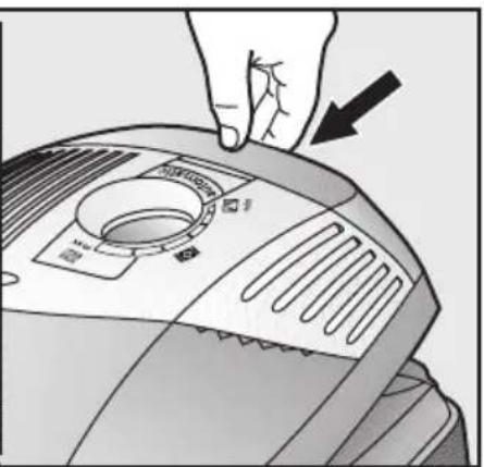 Illustration of a hand pressing down on a device with a circular dial and ventilation slots (no text or symbols visible)
