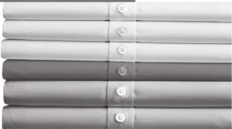 Stack of five gray fabric or garment pieces with button designs, no visible text or symbols