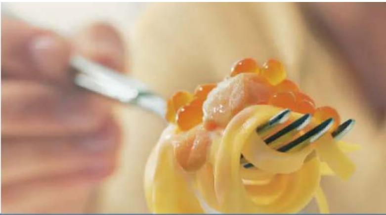 Close-up of a fork lifting a piece of pasta with visible toppings (no text or symbols)