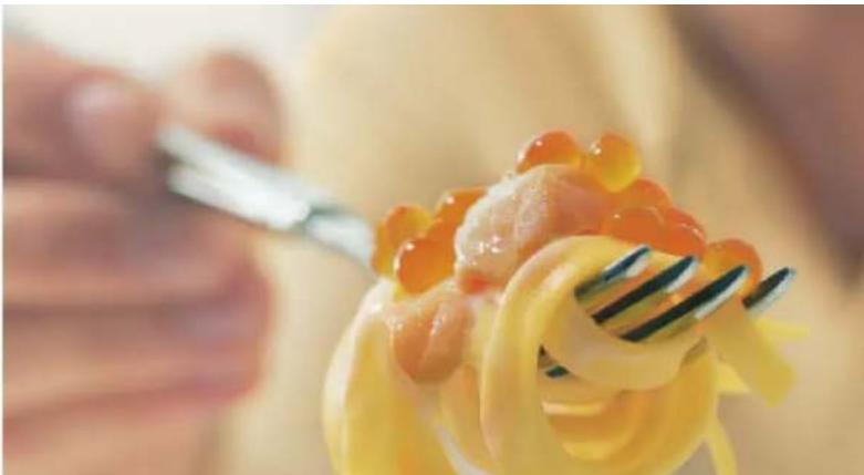 Close-up of a fork lifting a piece of pasta with visible toppings (no text or symbols)