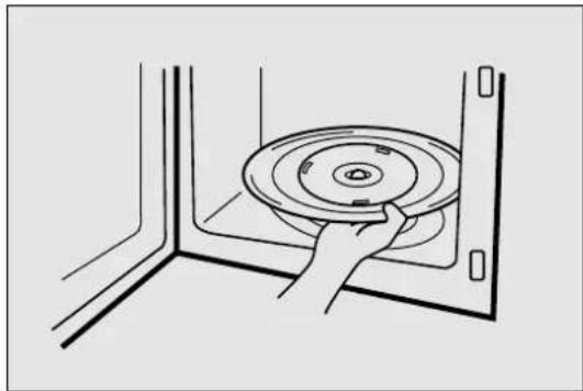 Line drawing of a hand holding a circular disc inside a corner (no text or symbols)