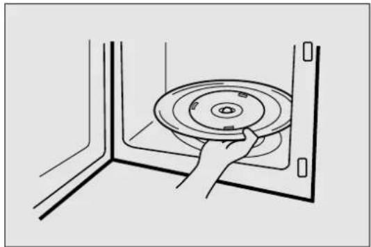 Line drawing of a hand holding a circular disc inside a corner (no text or symbols)