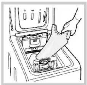 Line drawing of a hand inserting a plastic bag into an open appliance, no text or symbols.