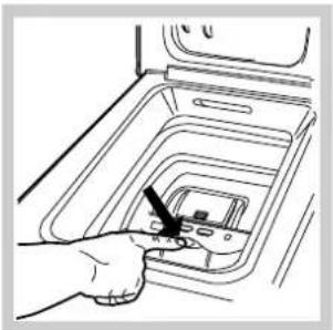 Hand inserting a small electronic component into a multi-tiered appliance, no text or symbols visible.