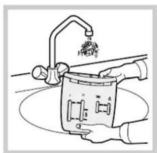 Illustration of hands using a cleaning tool to clean or wash a small appliance (no text or symbols visible)