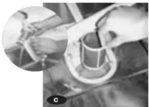 Close-up of hands operating a mechanical device with a cylindrical component, no visible text or symbols.
