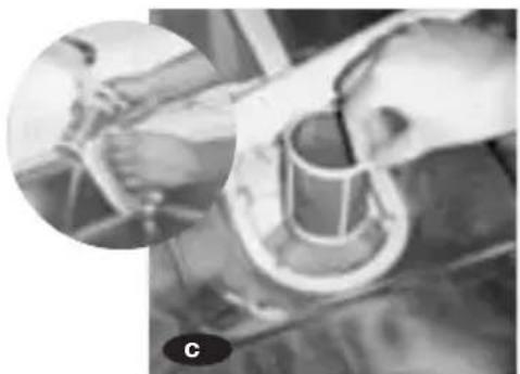 Close-up of hands operating a mechanical device with a cylindrical component, no visible text or symbols
