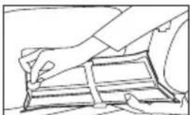 Line drawing of a hand holding a rectangular object, possibly a device or container.