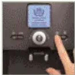 Close-up of a black electronic device with a screen displaying a logo and a finger pointing at it (no visible text or symbols)