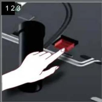Hand interacting with a red button on a device (no text or symbols visible)