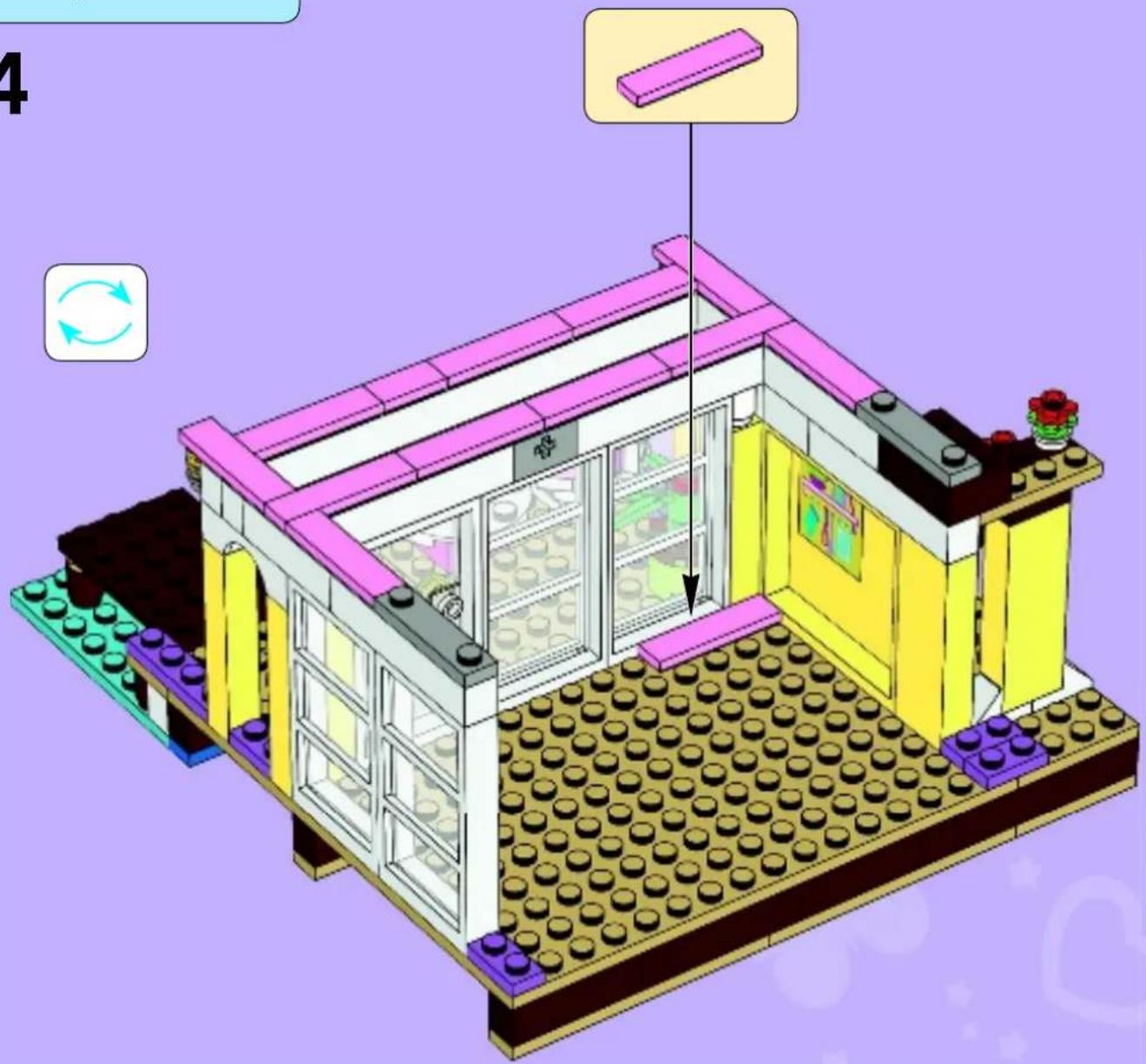 Lego-style building interior with pink roof and yellow walls, showing brickwork layout and a hanging door (no text or symbols)